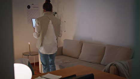 lady freelancer taking laptop sitting sofa at lamp light interior. relaxed woman