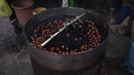 circular movement of a auto roasting machine roasting chestnuts, famous street food