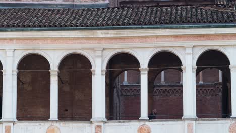 a couple stands in a historic courtyard in italy