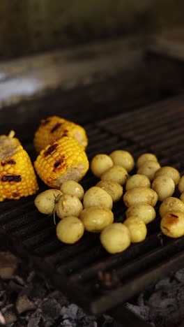 grilled corn, potatoes, and meat