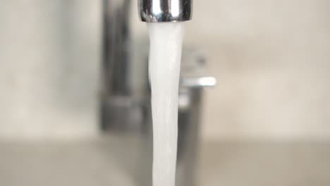 close up of water flowing from a faucet