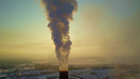 industrial smoke stack on a winter sunrise/sunset