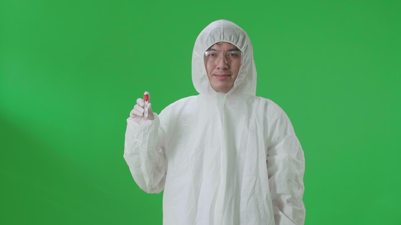 Asian Man Wearing Personal Protective Equipment Uniform Ppe And Holding A Glass Of Test Tube In The Green Screen Studio