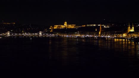 Budapest-city-center-view-with-Buda-Castle-and-Danube-river-at-night,-gothic-architecture,-light-reflections,-wide-distant-shot