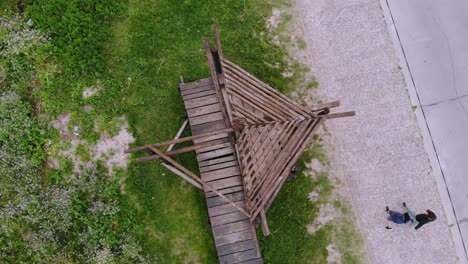 aerial video rising vertically from a wooden structure on the coast