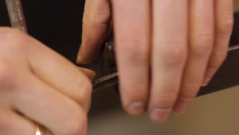 extreme closeup of inserting lathe threaded cutter into metal