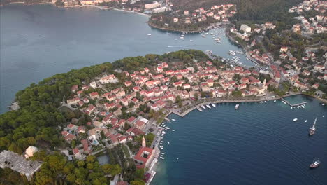 aerial video over small croatian coast town during sunset