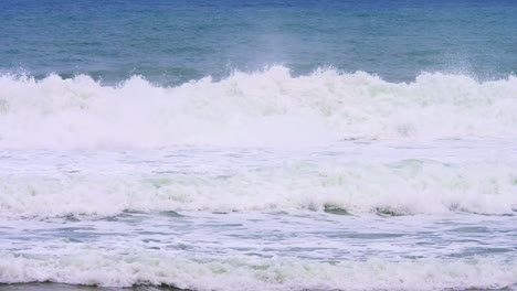 close up of slow motion barreling wave with wind spray and raw natural