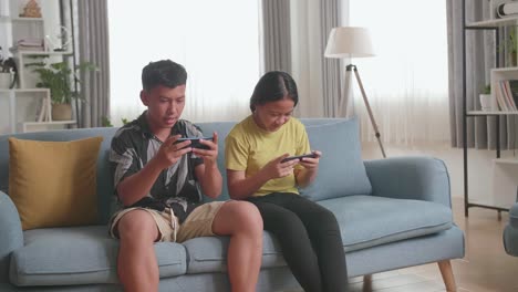 children playing games on phones on a couch