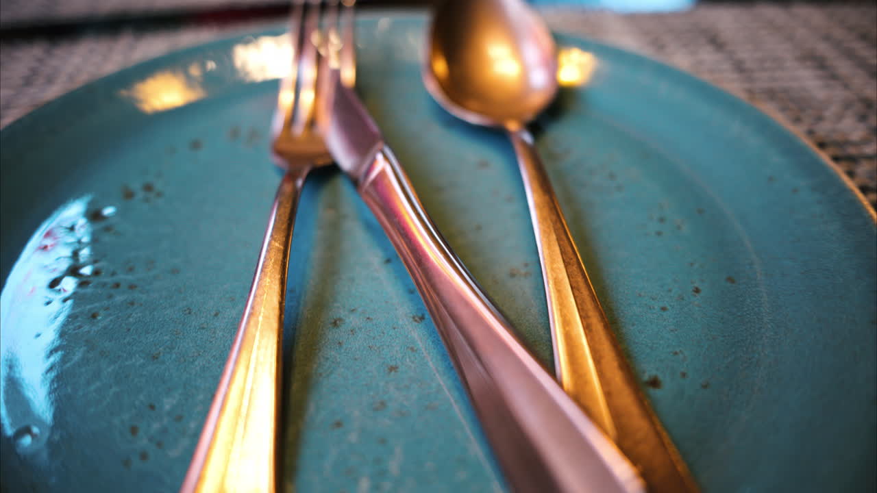 Stainless steel food cutlery on a ceramic plate