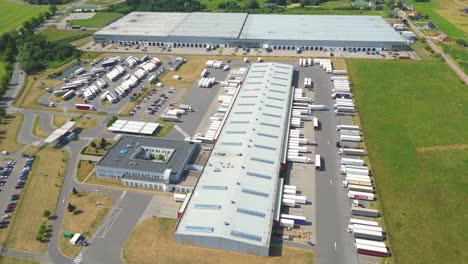 Aerial-view-of-warehouse-storages-or-industrial-factory-or-logistics-center-from-above