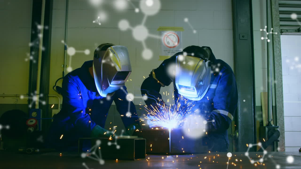 Animation of white molecules over male engineers welding