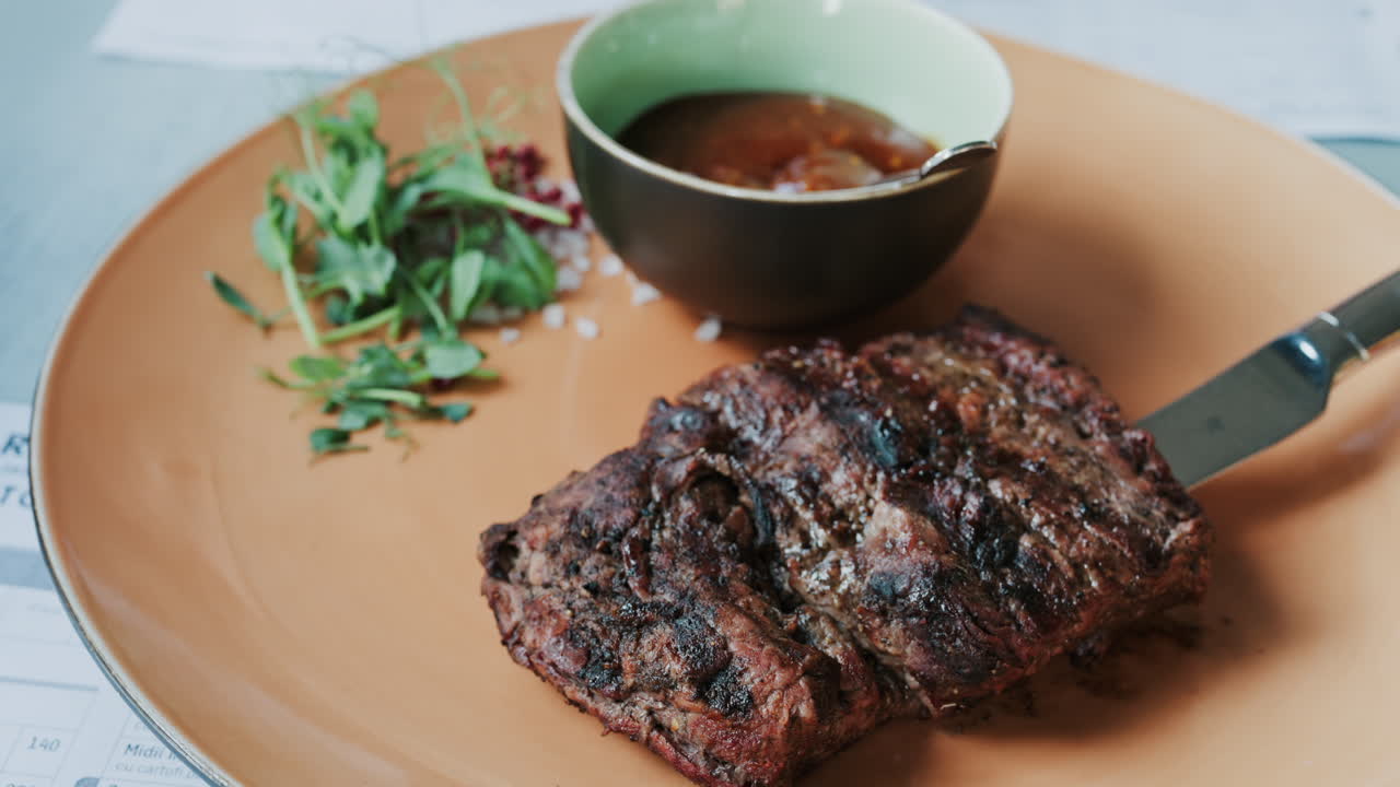 Close up of a Sirloin Steak with Barbecue Sauce and micro-plants on the side