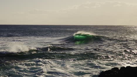 turbulent water flows under cloudy sunset light, textured sea surface ripples in golden hour