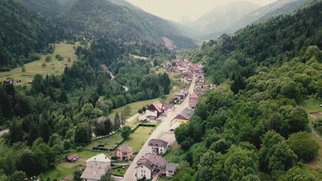 drone shot showing a village in the italian side of the alps