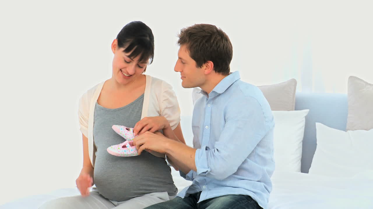 Cute couple playing with baby shoes