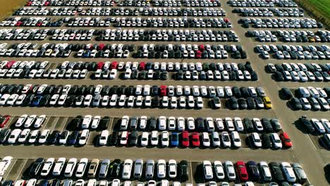 Aerial-footage-of-finished-cars-ready-to-be-shipped-on-huge-distribution-center