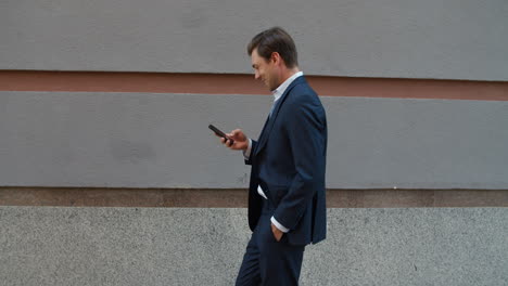 man looking smartphone outdoors