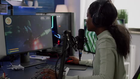 furious black woman gamer with headphones using stream chat losing game