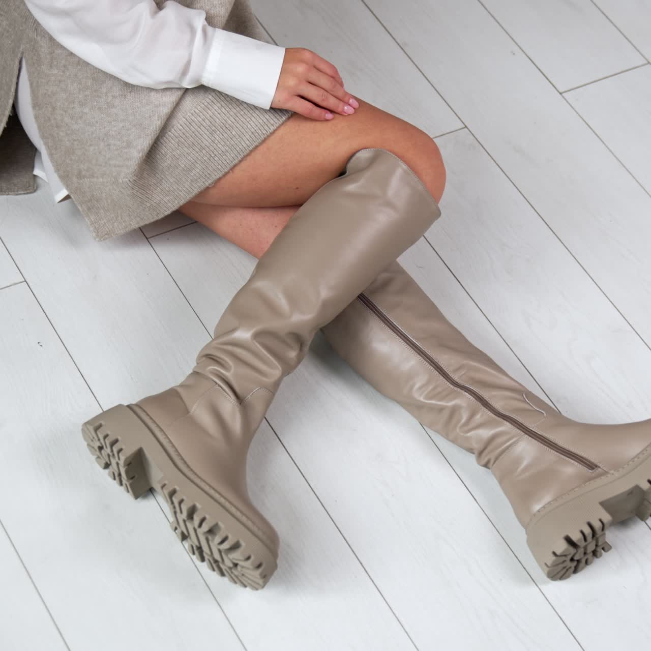 New style shoes showroom. Woman trying footwear in shoe store