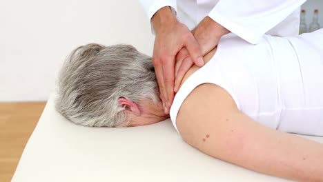 Doctor-rubbing-senior-patients-shoulders-