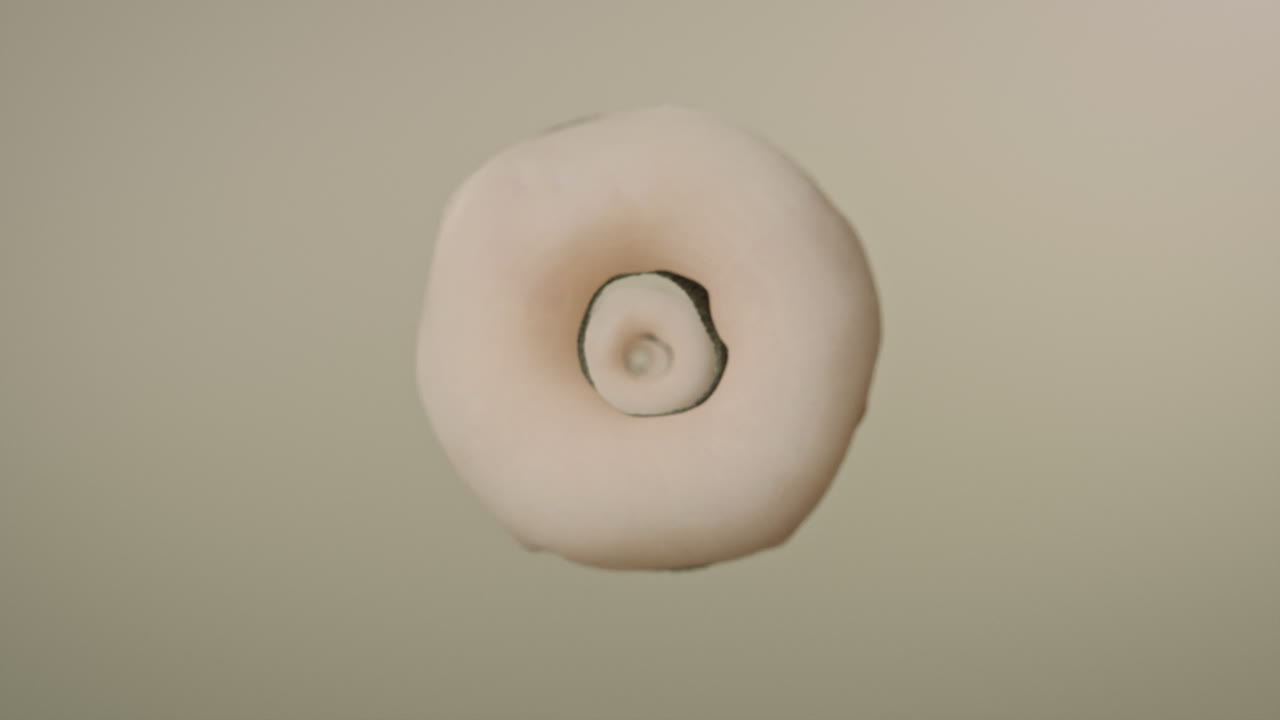 White glaze donuts on a light green background