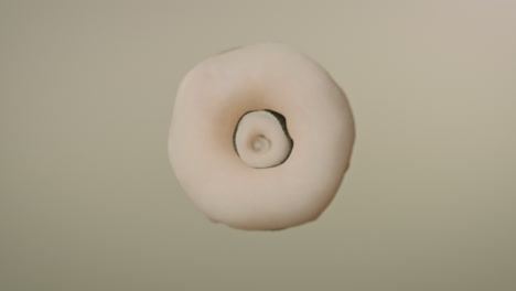 white glaze donuts on a light green background