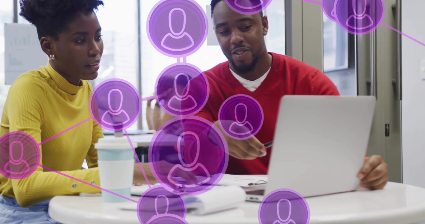 Man pointing at laptop causing purple network overlay while woman typing and writing for education
