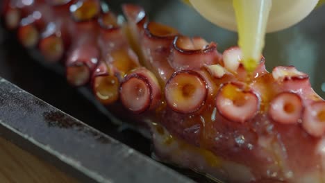 cooking an octopus in a charcoal oven