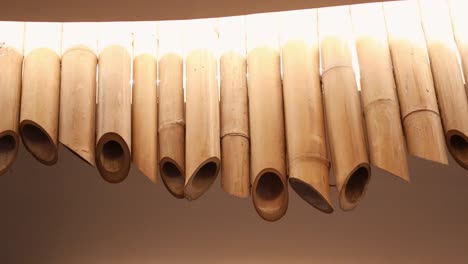 bamboo tubes hanging from a curved ceiling