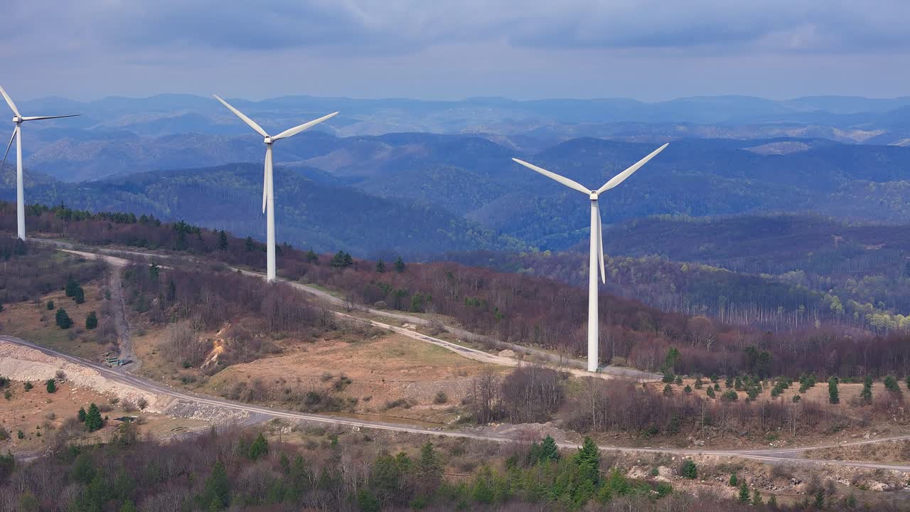Multiple wind turbines aligned along a ridge in West Virginia’s mountain landscape, USA