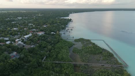 Aerial-of-Bacalar-Mexico-laguna-seven-colours-beach-resort-town-on-the-lake-high-angle-drone-footage