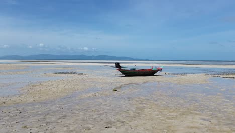 aerial drone video of colorful small fishing boat on the sandy coast of thong sala beach, koh phangan, thailand
