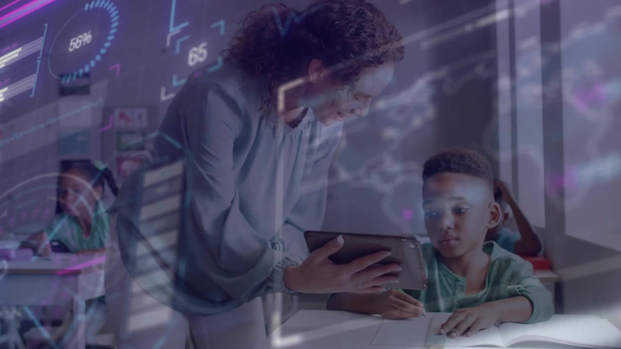 Teacher moving to student, guiding boy tapping tablet, writing in classroom as data graphics appear