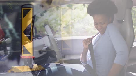 Animation-of-road-over-african-american-woman-driving-car