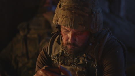 injured soldier using smartphone