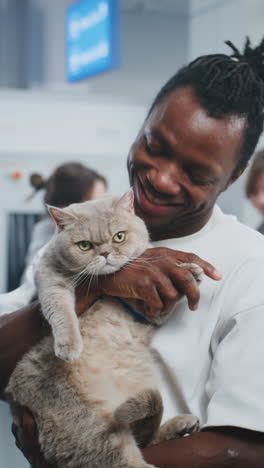 man holding a large cat at the airport