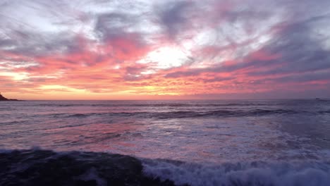 drone shot of the ocean during sunset