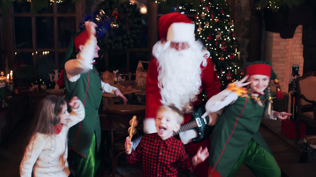 Santa Claus has fun, sings and dances with his children and elves in his New Year's residence
