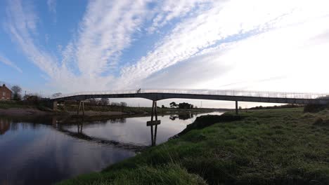 river footbridge early morning timelapse green banks fast moving clouds