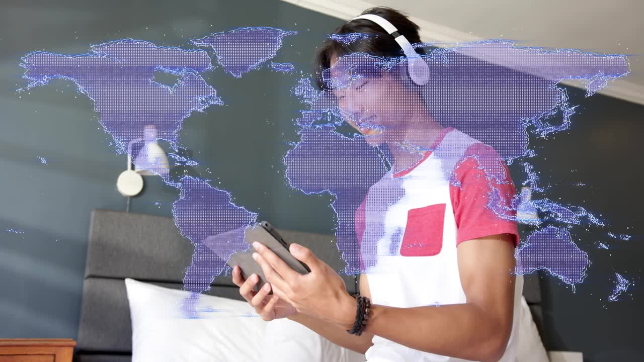 Teen male tapping tablet in bed, activating purple map overlay changing into dots for learning