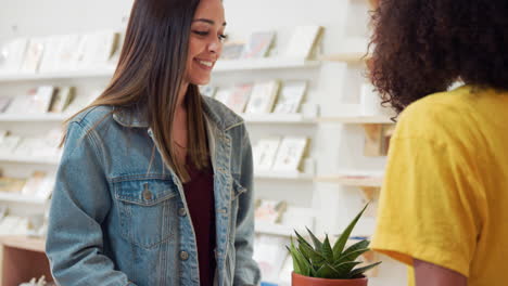 customer paying for plant at sales desk with credit card in gift shop