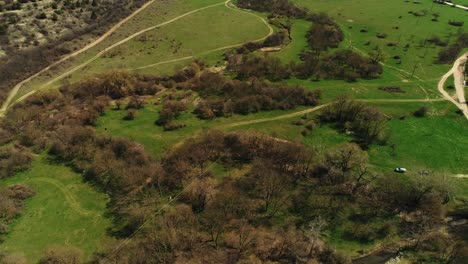 aerial view of a rural landscape with fields, forests, and paths