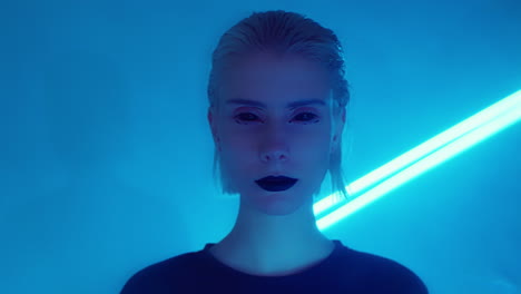 portrait of woman with black-out lenses in room with laser light