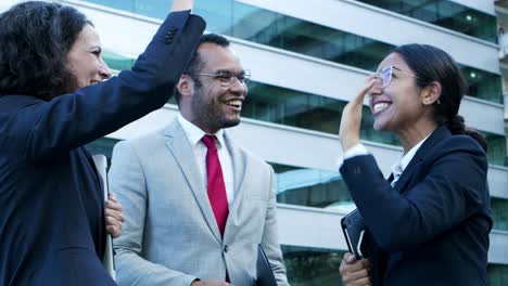 excited business people giving high five