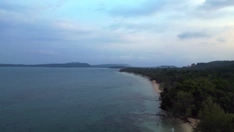 cambodia koh rong island, capturing the essence of tropical paradise with its lush palm trees, vibrant turquoise waters, and traditional stilt houses. wonderful aerial view overflight flyover drone