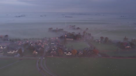 Burgum in Friesland, Dutch countryside covered in morning mist, aerial