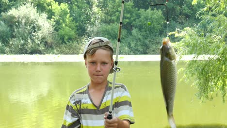 boy fishing and catching fish in a pond