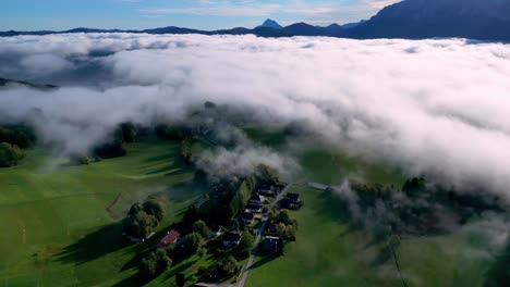 Aerial-view-of-a-small,-green-valley-nestled-amidst-rugged-mountains