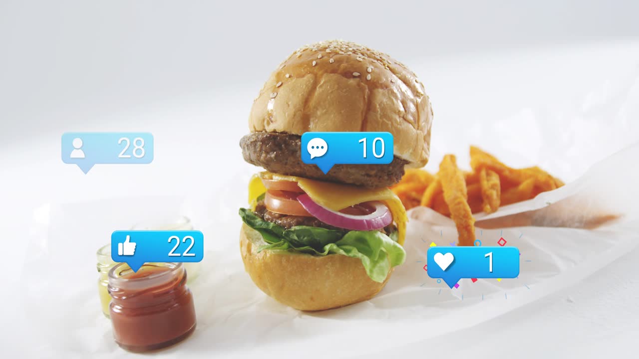 Blue badge popping, sesame burger rising, badges floating, hand placing fries, showing product